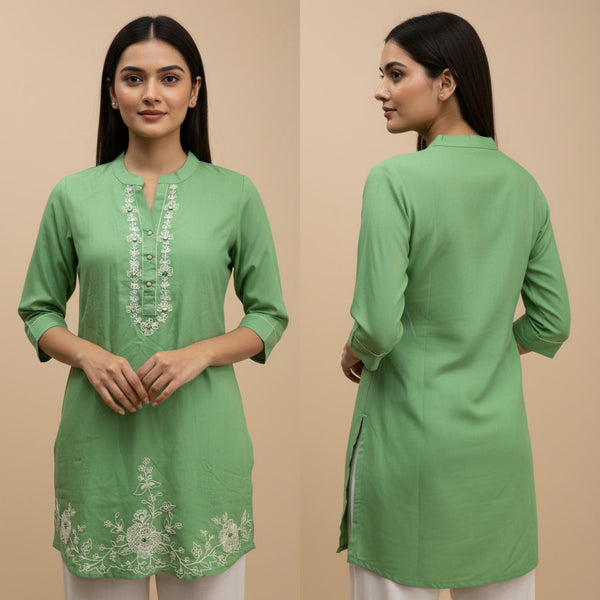 Green embroidered kurta worn by a model on a beige background
