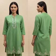 Green kurta with white embroidery on a beige background