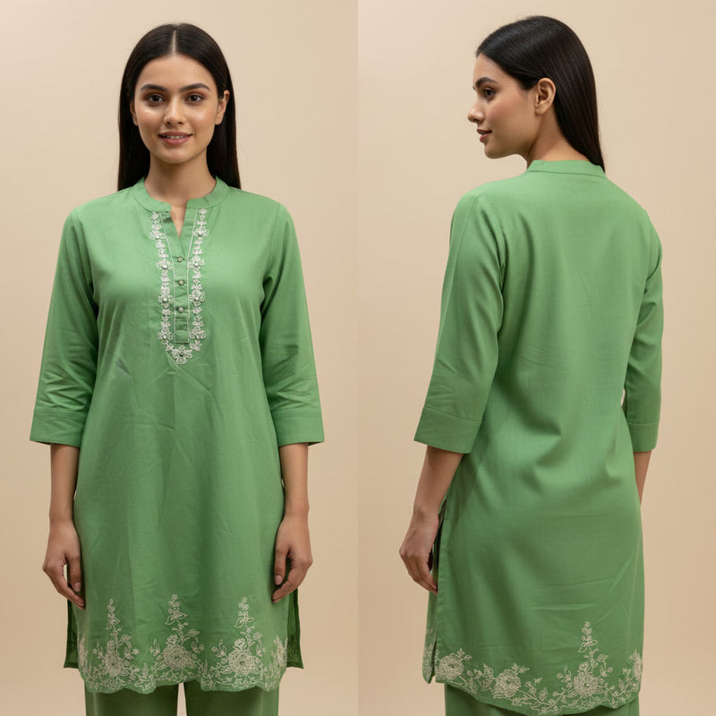Green kurta with white embroidery on a beige background