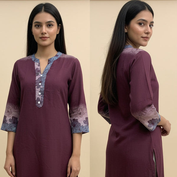 Woman wearing a maroon kurta with floral patterns on a beige background