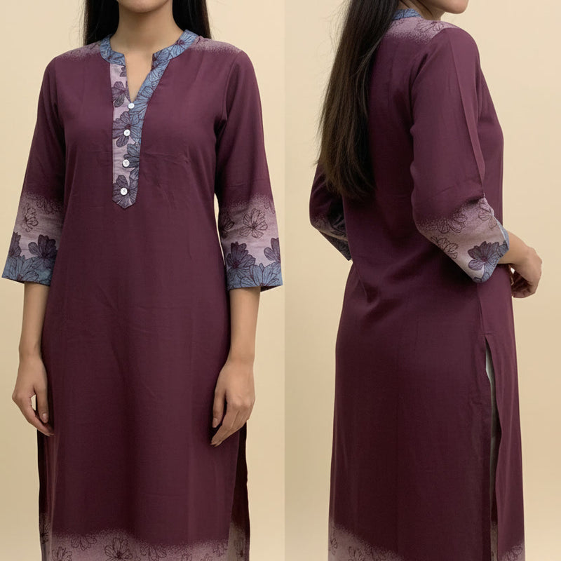 Woman wearing a maroon kurta with floral patterns on a beige background
