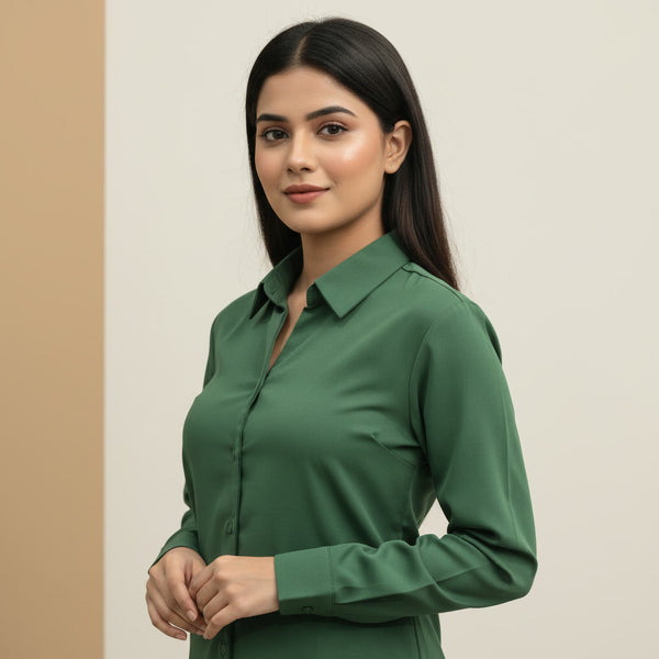 Woman wearing a green shirt against a beige background