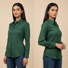 Woman wearing a green shirt and blue jeans on a beige background