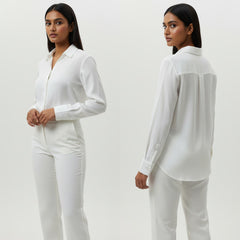 Woman wearing a white outfit against a plain background