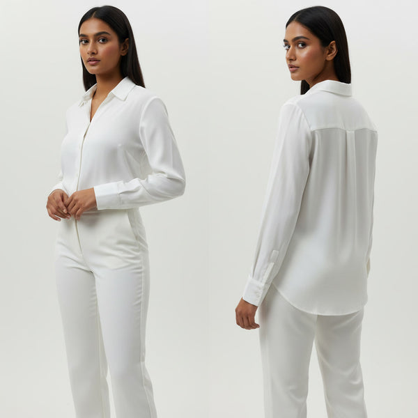 Woman wearing a white outfit against a plain background