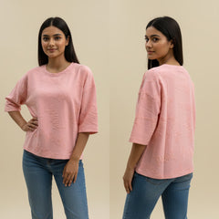 Woman wearing a pink top and blue jeans, shown from front and back on a beige background