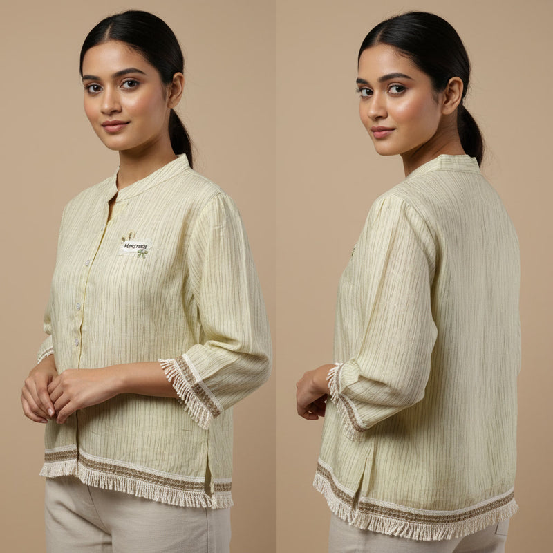 Woman wearing a cream-colored traditional outfit with intricate patterns on a beige background