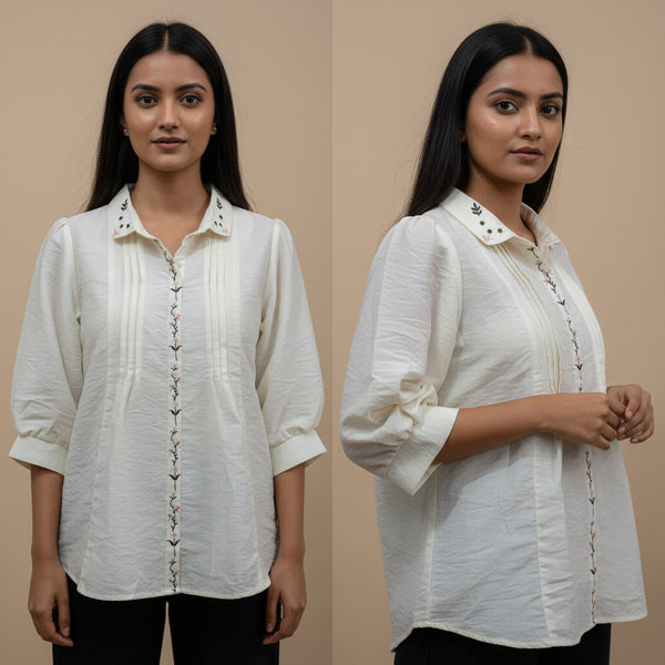 Woman wearing a white blouse with intricate details on a beige background