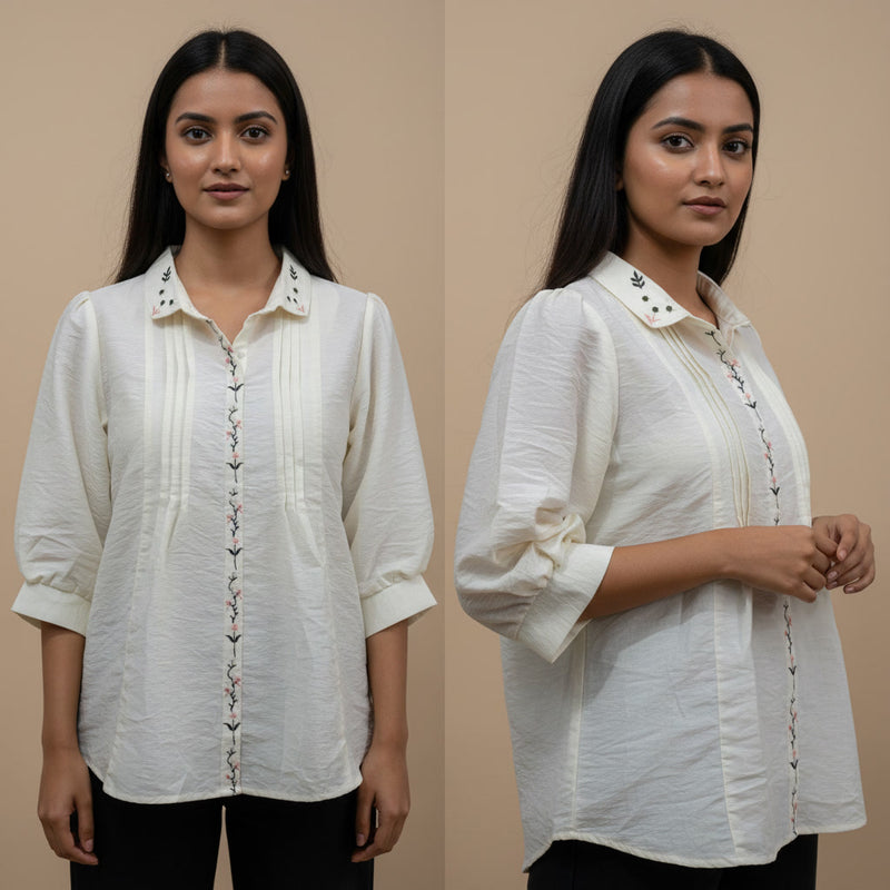 Woman wearing a white blouse with intricate details on a beige background