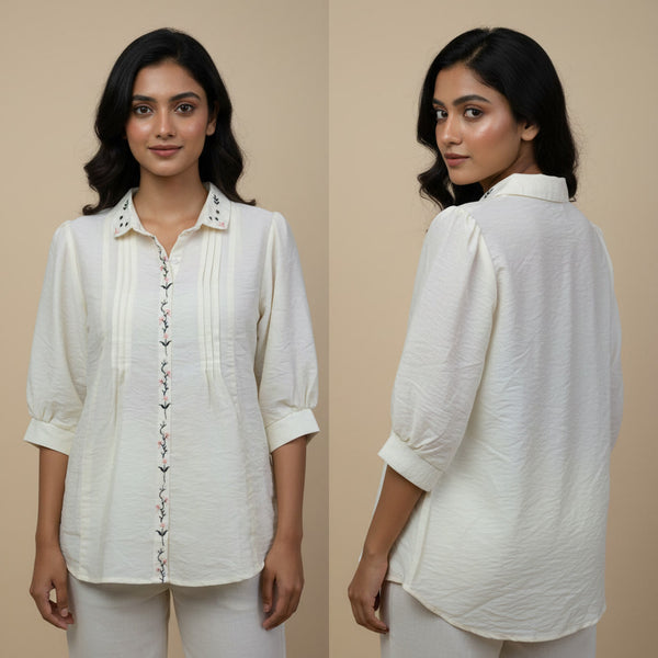 Woman wearing a white shirt with a beige background
