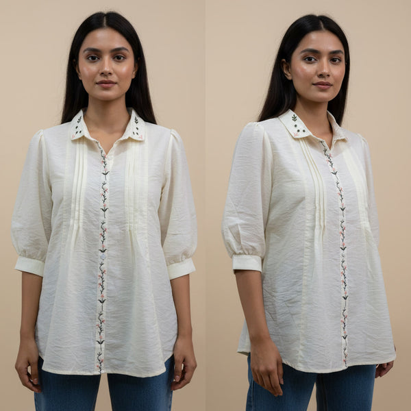 Woman wearing a white blouse with decorative buttons on a beige background