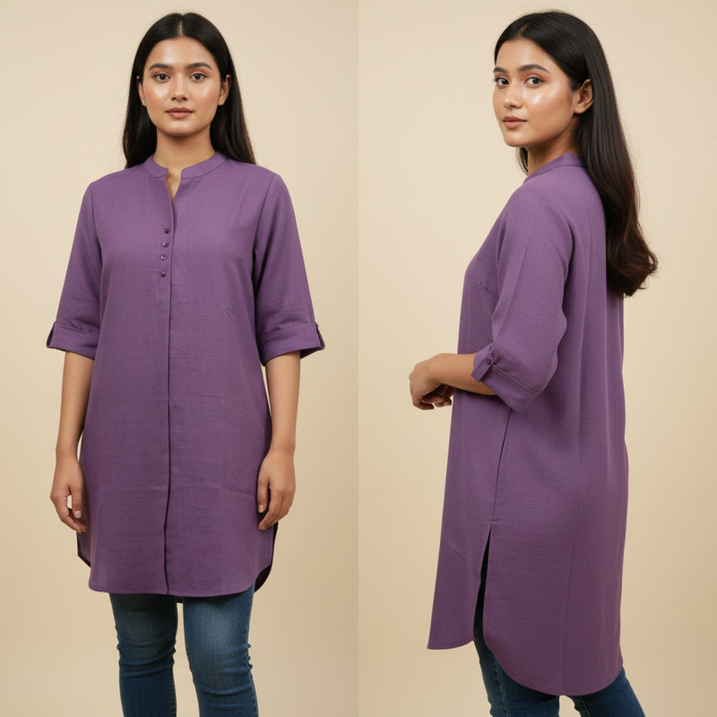 Woman wearing a purple kurta with a plain background