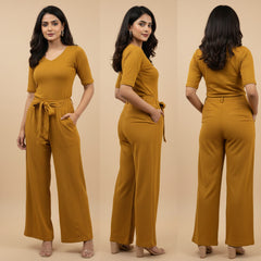 Woman wearing a mustard yellow jumpsuit from front, side, and back views on a beige background