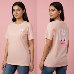 Woman wearing a pink t-shirt with a graphic design on a pink background