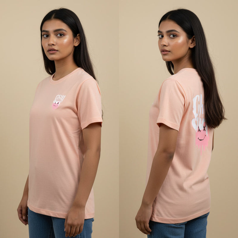 Woman wearing a pink t-shirt with a graphic design on a beige background