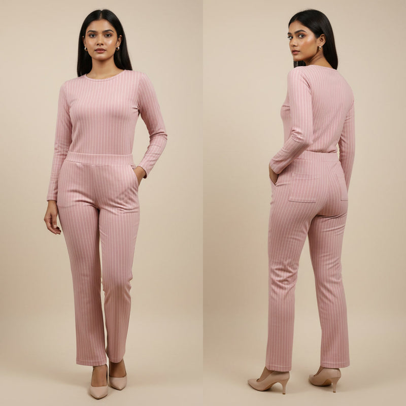 Woman wearing a pink ribbed outfit with long-sleeve top and pants on a beige background