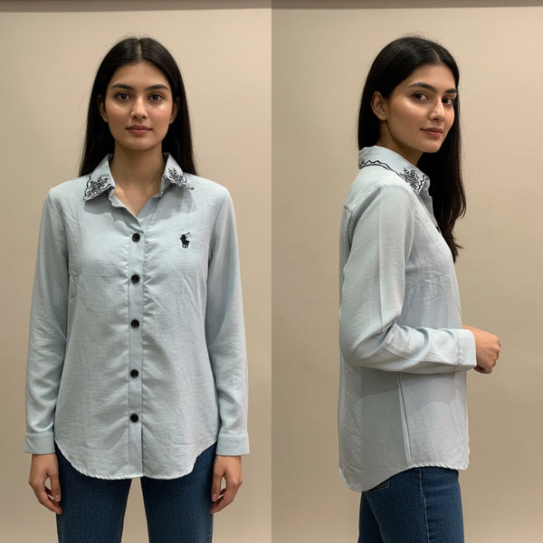 Woman wearing a light gray shirt with a brand logo, shown from front and side views against a beige background.