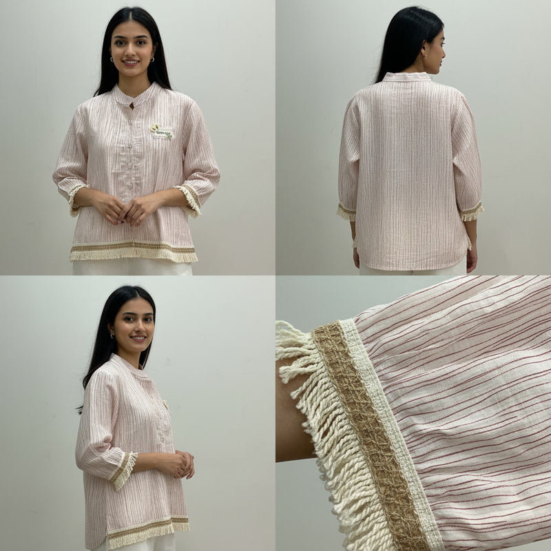 Woman wearing a light pink traditional outfit with a close-up of the fabric detail on a plain background.