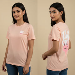 Woman wearing a pink t-shirt with text and graphics on a beige background
