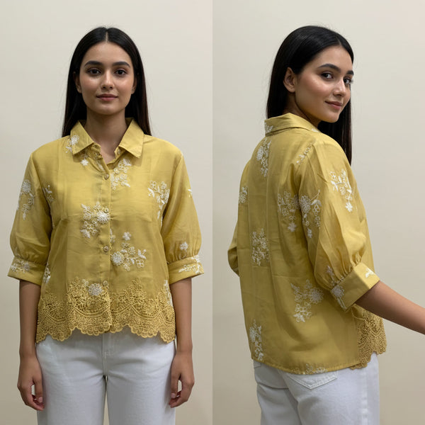 Woman wearing a yellow embroidered blouse with white pants, shown from front and back.