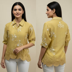 Woman wearing a yellow embroidered shirt with lace details, shown from front and back on a beige background.